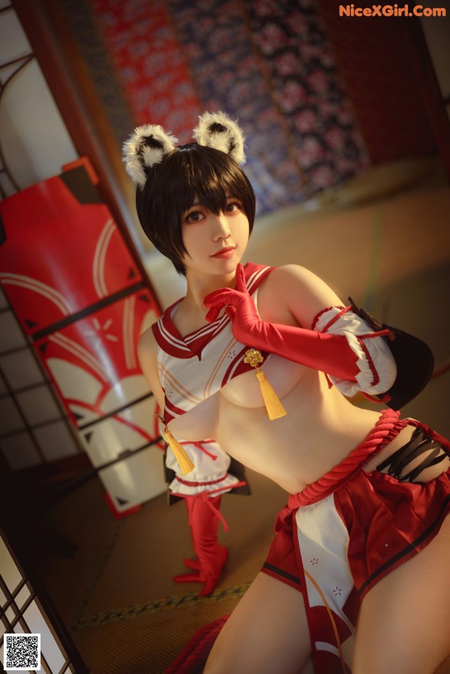 A woman in a red and white outfit posing for a picture.