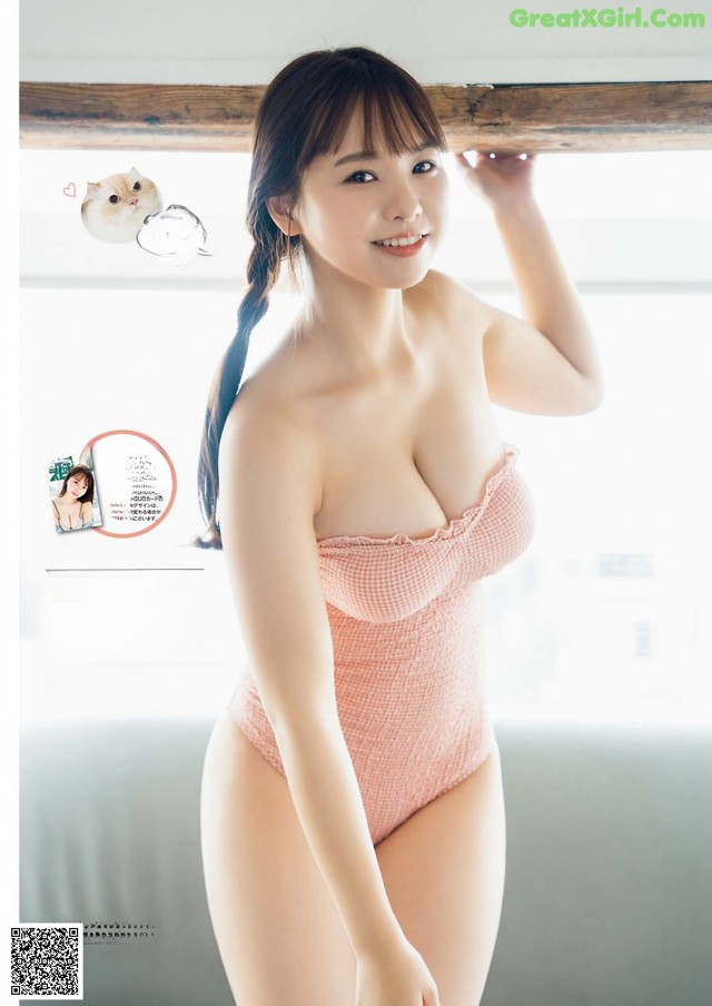 A woman in a pink bathing suit posing for a magazine.